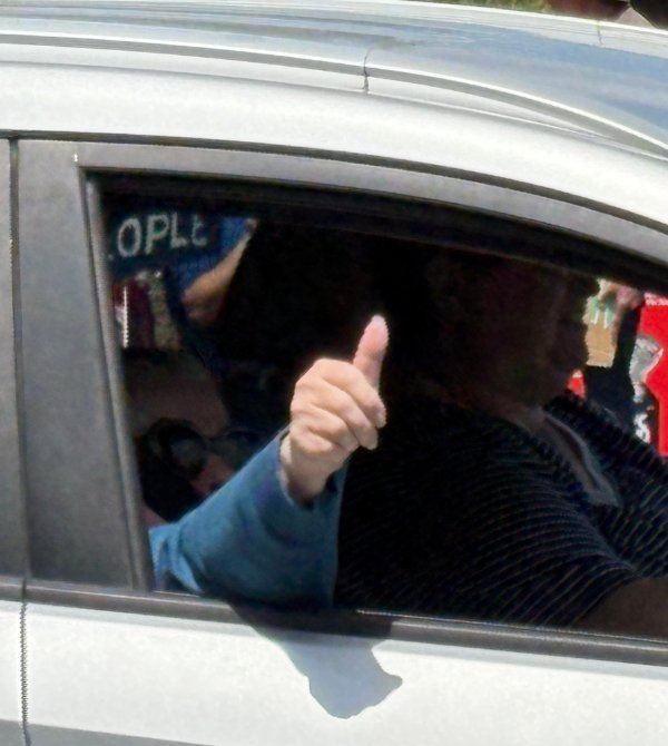 thumbs up from a supporter in a car
